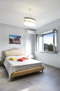 a bedroom with a large bed and a window at Villa Ida - Free private Parking in Sarno