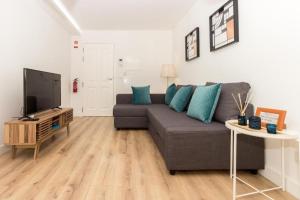 a living room with a couch and a tv at Oporto Modern Apartments - Campanha Train Station in Porto