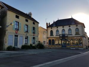 a group of buildings on a city street at La Palette Fleurie in Laignes