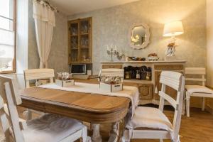 a dining room with a table and chairs at La Palette Fleurie in Laignes