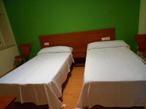 Postel nebo postele na pokoji v ubytování Pension San Roque