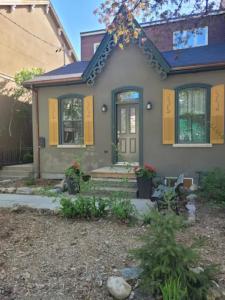 a house with yellow doors and a bench in front of it at Gabby's Place Downtown Core in Toronto