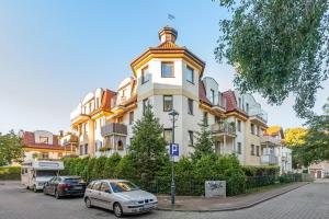 a building with a car parked in front of it at Lion Apartments - Amalfi Quiet Family 3 Bedr Apartment in Sopot