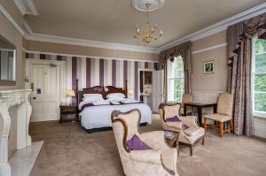 a bedroom with a bed and a table and chairs at St Nicholas House in Spalding