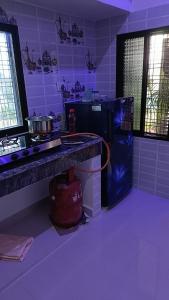 a kitchen with a counter and a stove top oven at The Mountain View Home Stay in Khajurāho