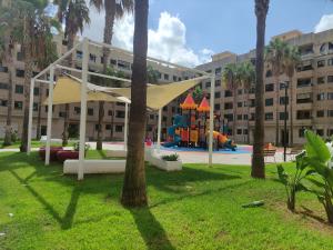 a park with a playground in front of a building at Biopark View Apartment in Valencia