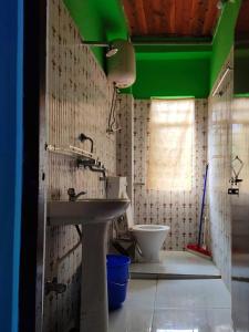 a bathroom with a sink and a toilet at 3 Sisters' Homestay in Ravangla