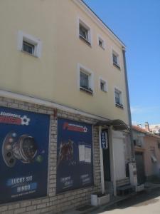 a building with a sign on the side of it at Pansion Most in Mostar