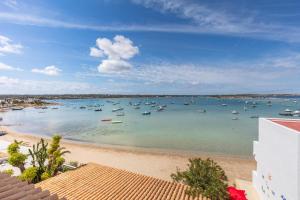 a view of a harbor with boats in the water at Hostal la Savina in La Savina