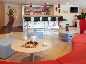a cafe with a chess board on a table in the lobby at ibis Velizy Jouy-En-Josas in Jouy-en-Josas