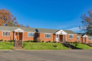 a large brick house with a driveway at Natural Bridge Hotel, Trademark Collection by Wyndham in Natural Bridge