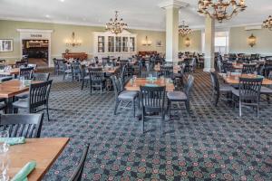a dining room with tables and chairs and chandeliers at Natural Bridge Hotel, Trademark Collection by Wyndham in Natural Bridge