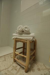 a pile of towels sitting on top of a stool at Hostal Marblau Ibiza in Ibiza Town