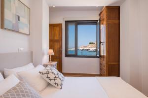 a bedroom with a bed and a window at Pasifai Residence - Chania old town in Chania Town