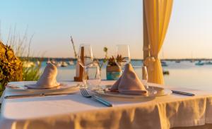 a table with two glasses and napkins on it at Hostal la Savina in La Savina