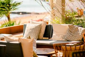 a patio with pillows and a table with a couch at Hostal la Savina in La Savina