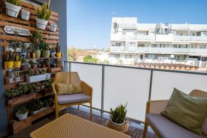 a balcony with a chair and some plants at Calm Home La Tejita in Granadilla de Abona