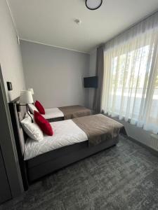 Postel nebo postele na pokoji v ubytování Tõrva Veemõnula Spaahotell