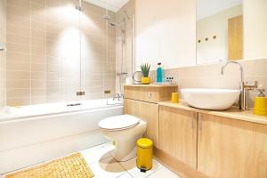a bathroom with a toilet and a sink and a tub at Willowbank Road Apartments - Grampian Lettings Ltd in Aberdeen