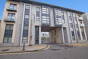 a large brick building with a large door at Willowbank Road Apartments - Grampian Lettings Ltd in Aberdeen