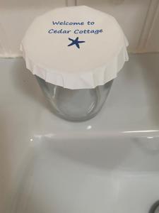 a silver toilet bowl with a welcome to seafarer course sign at Cedar Cottage in Warrenpoint