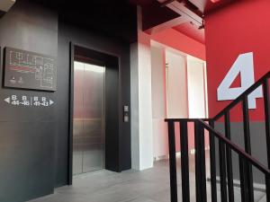 a elevator in a building with a red wall at Penpark Place in Bangkok
