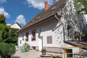 an exterior view of a white house with a patio at Sylvia Ház in Tihany