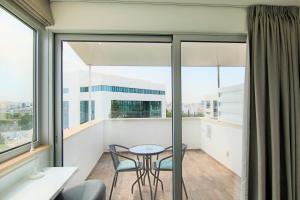 a balcony with a table and chairs and a window at Phaedrus Living: Luxury Suite Nicosia 507 in Nicosia