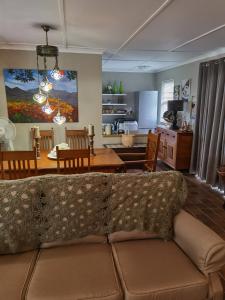 a living room with a couch and a dining room at Misty peaks Cloudlands in Bergview