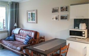 a living room with a couch and a table at Gorgeous Apartment In Darlowo With Wifi in Darłowo