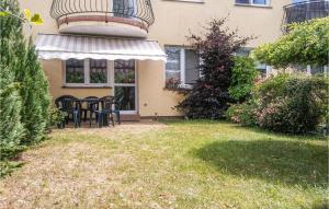 a house with a table and chairs in the yard at 2 Bedroom Beautiful Apartment In Darlowo in Darłowo