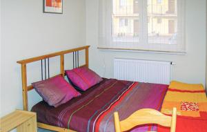 a bedroom with a bed with two pillows on it at 2 Bedroom Beautiful Apartment In Darlowo in Darłowo