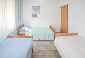 a room with two beds and a window at House Romano in Neviđane