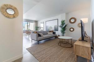 a living room with a couch and a table at 71-Beachfront, brand new luxury penthouse Benalmádena in Benalmádena