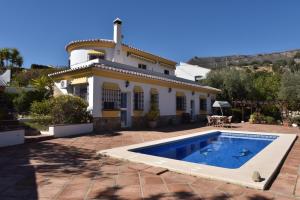 una casa con piscina frente a ella en Siempre Verde, en Alcaucín