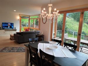a dining room and living room with a table and chairs at Apartment Bella Vista in Bad Kleinkirchheim