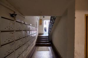 an empty hallway with stairs in a building at Dembi at the Great City Park in Budapest