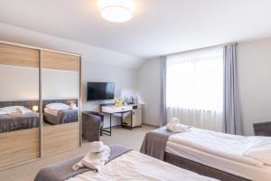 a hotel room with two beds and a desk at Pokoje Gościnne Cichosza in Szklarska Poręba