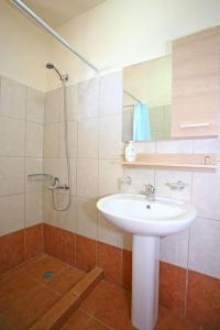 a bathroom with a sink and a shower at On The Beach Apartments in Hora Sfakion