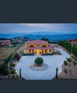 a large house with a driveway in front of it at Villa Panorama in Oratino