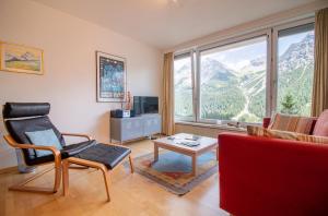 a living room with a view of a mountain at Viktoria B42 by Arosa Holiday in Arosa