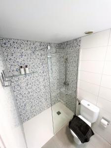 a bathroom with a shower and a toilet at Salitre Ocean Sunset in El Cotillo +12 photos