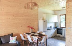 a kitchen and dining room with a table and chairs at Cozy Home In Kolczewo With Kitchen in Kołczewo