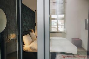 a bedroom with a bed with a window and a mirror at Apartements Zum Roten Lamm in Bad Krozingen