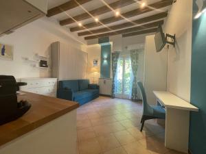 a kitchen and living room with a table and a blue couch at Porta Romana Bella in Milan