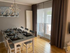 a dining room with a table and chairs and a window at Family House in Kappeln