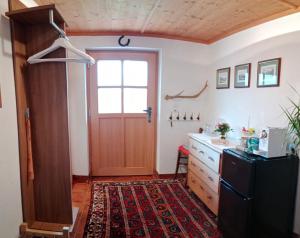 a kitchen with a black refrigerator and a door at Haus Horvath Bett und Brot in Altaussee