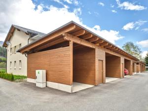 a row of garages in front of a building at Sunlodge Oeblarn Top C3 Schladming-Dachstein in Öblarn