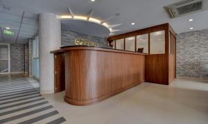 a lobby with a reception desk in a building at Hotel Garden Inn in Cochin