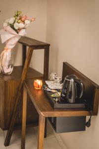 a small wooden table with a tea kettle on it at Casa Ra in Podgorica